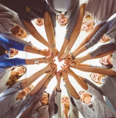 women in business holding hands heart centered business JAGmedia